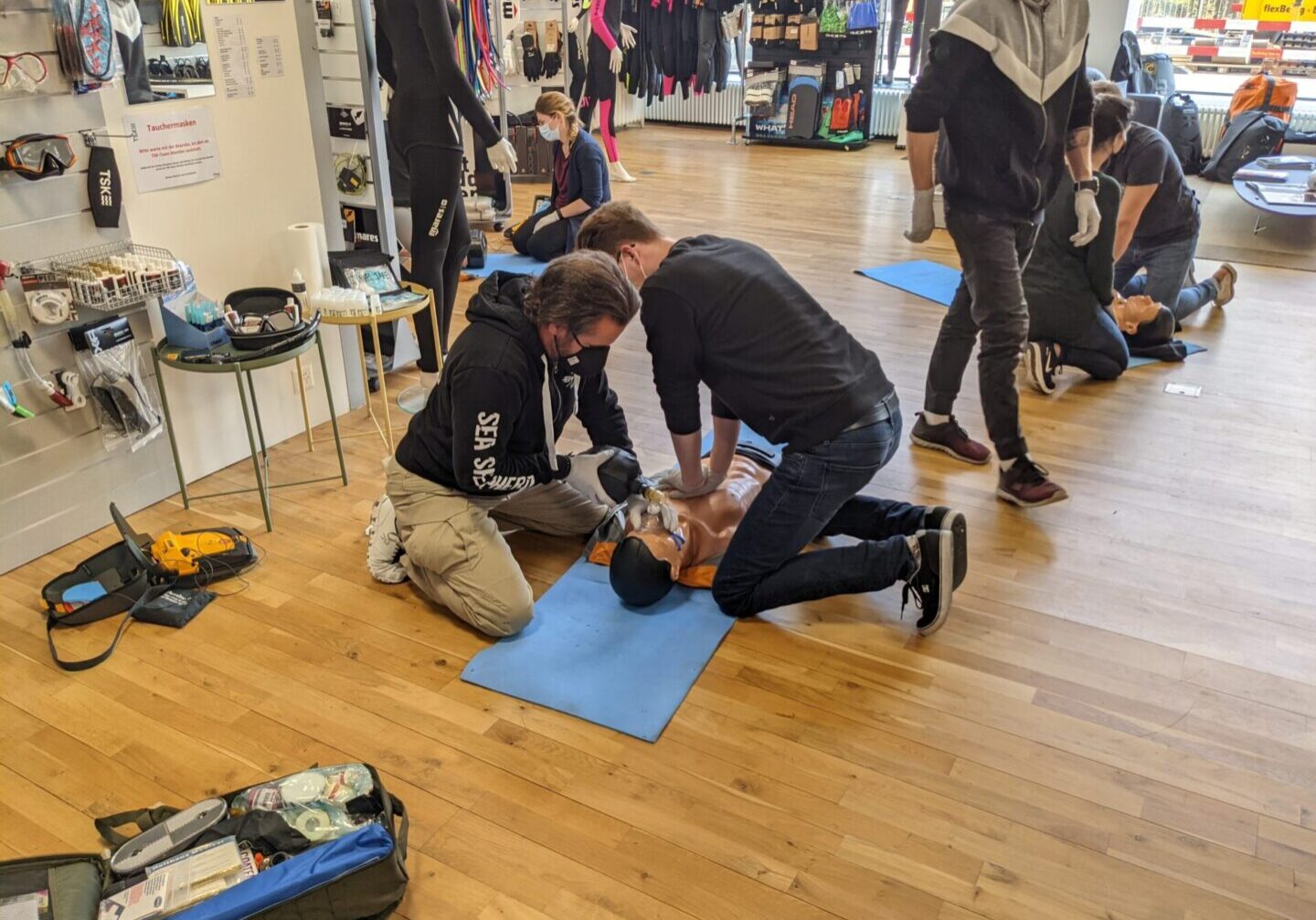 Group of people having a training about first aid process