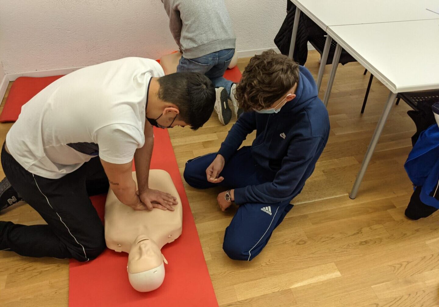 Men doing chest pump on a dummy