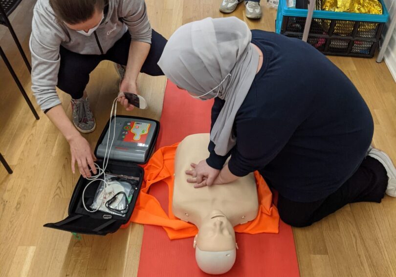 Trainee doing chest pump on a dummy